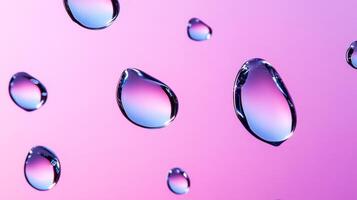 Drops of water on glass creating abstract shapes with a gradient pink and purple background photo