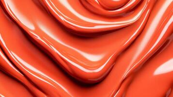 Swirls of rich coppery red liquid lipstick creating an abstract pattern on a soft muted orange background photo