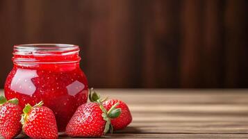 Strawberry jam in a jar on a wooden table photo