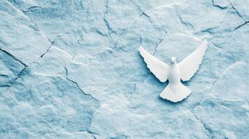 Rough grainy stone texture in light blue and white tones for International Peace Day subtle cracks forming a dove shape soft texture adds calmness and serenity to the image photo