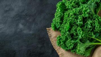 Bunches of green kale with curly leaves on a burlap sack market stall background rustic vibe photo