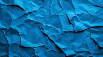 Crinkled blue paper background with deep creases and shadows creating a textured worn effect photo