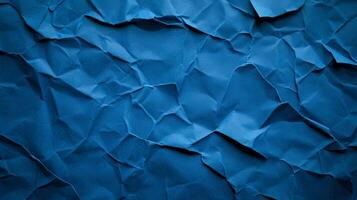 Crinkled blue paper background with deep creases and shadows creating a textured worn effect photo