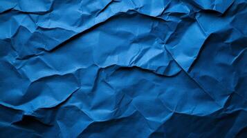 Crinkled blue paper background with deep creases and shadows creating a textured worn effect photo