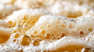 Detailed close up of an Oktoberfest beer stein overflowing with foam showing rich golden hues and bubbles photo