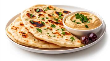 Flatbreads with hummus dip on white background photo