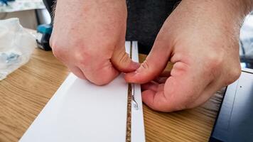 Close up of Caucasian hands assembling flat pack furniture, highlighting home DIY challenges and interior decoration projects photo