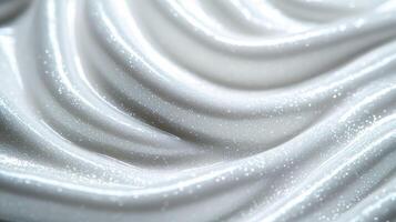 Closeup of a creamy snow white serum with tiny iridescent flakes resembling a glistening winter frost photo