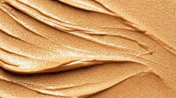 Closeup of golden highlighter cream texture with fine metallic flecks on a smooth surface luxurious beauty product detail photo
