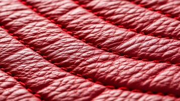 Closeup of textured red leather with a bold vibrant hue and slightly distressed finish capturing rugged elegance photo