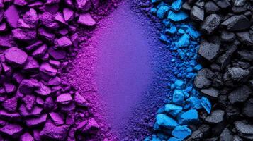 Crushed jewel toned eyeshadow powders in sapphire and amethyst shades creating a colorful textured background photo