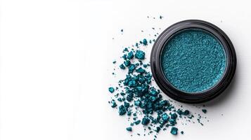 Deep icy teal eyeshadow with a metallic finish creating a sparkling contrast against a frosty white background photo