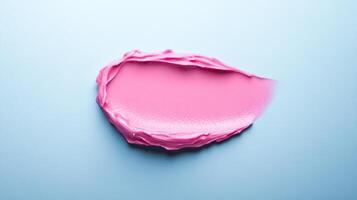 Frosted pink lip balm smear with a subtle sheen on a soft grey blue background mimicking winter morning light photo
