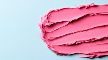 Frosted pink lip balm smear with a subtle sheen on a soft grey blue background mimicking winter morning light photo