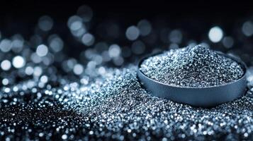 Glittering silver eyeshadow powder spread with uneven texture on a black velvet background twinkling under direct light photo