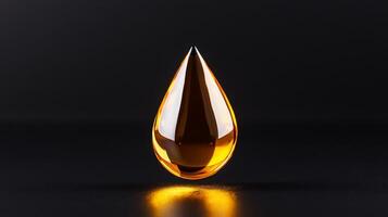 Golden facial oil drop glistening against a matte black background capturing light through its transparent form photo