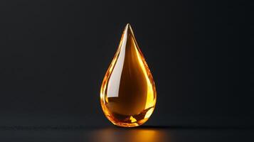 Golden facial oil drop glistening against a matte black background capturing light through its transparent form photo