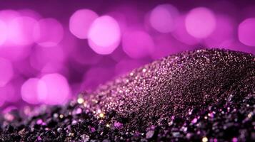 Macro of warm taupe eyeshadow with hints of gold sparkles blending into a deep plum background photo