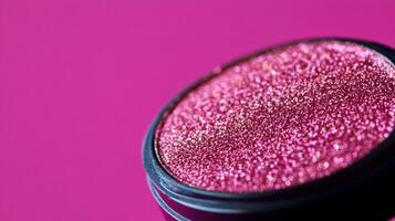 Macro of warm taupe eyeshadow with hints of gold sparkles blending into a deep plum background photo