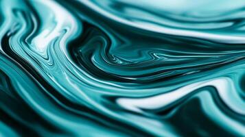 Macro shot of swirling blue and green marbled nail polish blending into fluid abstract waves with a glossy finish photo