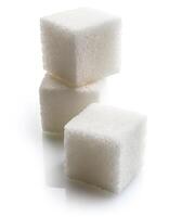 Close-up of three white sugar cubes, isolated on white background photo