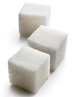 Close-up of three white sugar cubes, isolated on white background photo