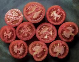 Overhead view of Fresh Ripe juicy red Tomato halves food summer background photo