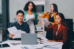 Stress, business people and employee frustrated with multitasking, pressure or overworked by team in chaos with paperwork. Anxiety, headache and worker overwhelmed by group and burnout in crisis photo