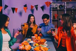 Joyful office Halloween party with coworkers in costumes, celebrating with drinks and laughter, fostering teamwork and festive spirit photo