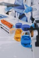 Scientist using microscope in laboratory. Close-up of a researcher's hands adjusting a modern microscope in a lab setting. Science concept photo
