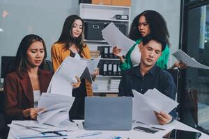 Stress, business people and employee frustrated with multitasking, pressure or overworked by team in chaos with paperwork. Anxiety, headache and worker overwhelmed by group and burnout in crisis photo
