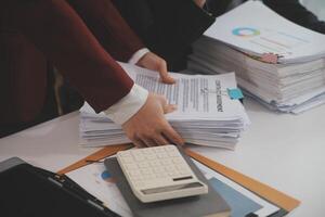 Audit concept,Administrator business man financial inspector and secretary making report calculating balance. Internal Revenue Service checking document. photo