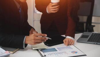 Audit concept,Administrator business man financial inspector and secretary making report calculating balance. Internal Revenue Service checking document. photo