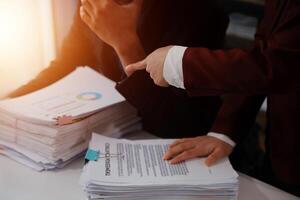 Audit concept,Administrator business man financial inspector and secretary making report calculating balance. Internal Revenue Service checking document. photo
