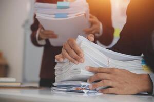 Audit concept,Administrator business man financial inspector and secretary making report calculating balance. Internal Revenue Service checking document. photo