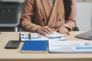 business documents businessman check legal document review Prepare documents or analysis reports, tax items, accounting documents, data contracts, office partner agreements. photo