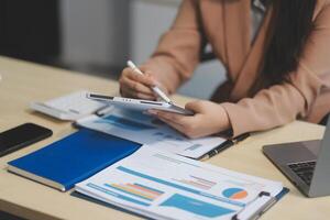 business documents businessman check legal document review Prepare documents or analysis reports, tax items, accounting documents, data contracts, office partner agreements. photo