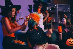 Joyful office Halloween party with coworkers in costumes, celebrating with drinks and laughter, fostering teamwork and festive spirit photo