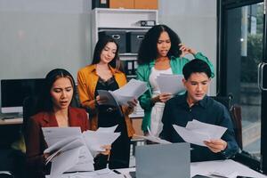 Stress, business people and employee frustrated with multitasking, pressure or overworked by team in chaos with paperwork. Anxiety, headache and worker overwhelmed by group and burnout in crisis photo