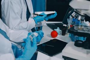 Scientist using microscope in laboratory. Close-up of a researcher's hands adjusting a modern microscope in a lab setting. Science concept photo