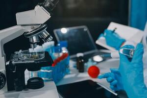 Scientist using microscope in laboratory. Close-up of a researcher's hands adjusting a modern microscope in a lab setting. Science concept photo