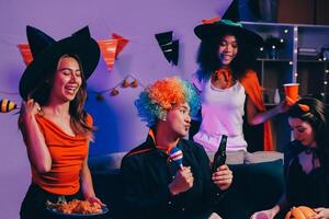 Joyful office Halloween party with coworkers in costumes, celebrating with drinks and laughter, fostering teamwork and festive spirit photo