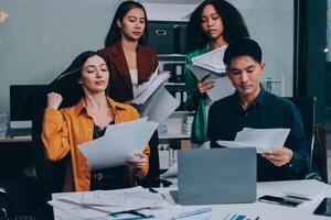 Stress, business people and employee frustrated with multitasking, pressure or overworked by team in chaos with paperwork. Anxiety, headache and worker overwhelmed by group and burnout in crisis photo