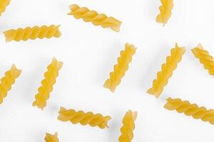 Pasta products in the form of a spiral, texture, on a white background photo