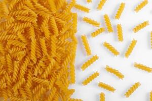 Pasta products in the form of a spiral, texture, on a white background photo