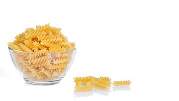 Pasta products in the form of a spiral on a plate, texture, on a white background photo
