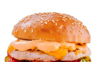 Juicy burger with melted cheese and sauce is waiting to be eaten photo