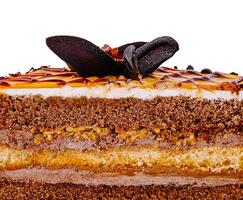 Delicious chocolate cake with caramel and chocolate topping showing its layers photo