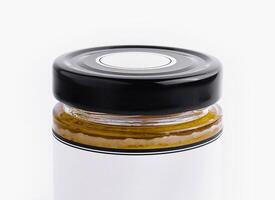 Glass jar with black lid on white background photo