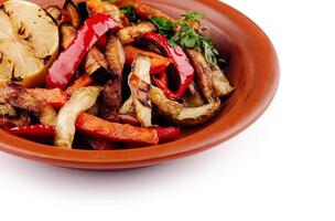 Grilled vegetables on plate with lemon, healthy vegan lunch photo